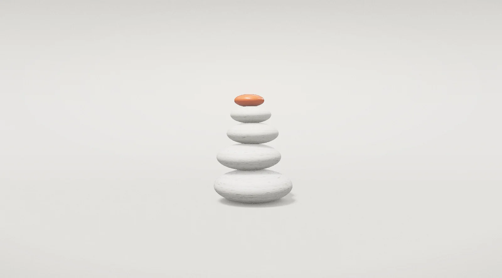 A cairn of stones, the top one orange