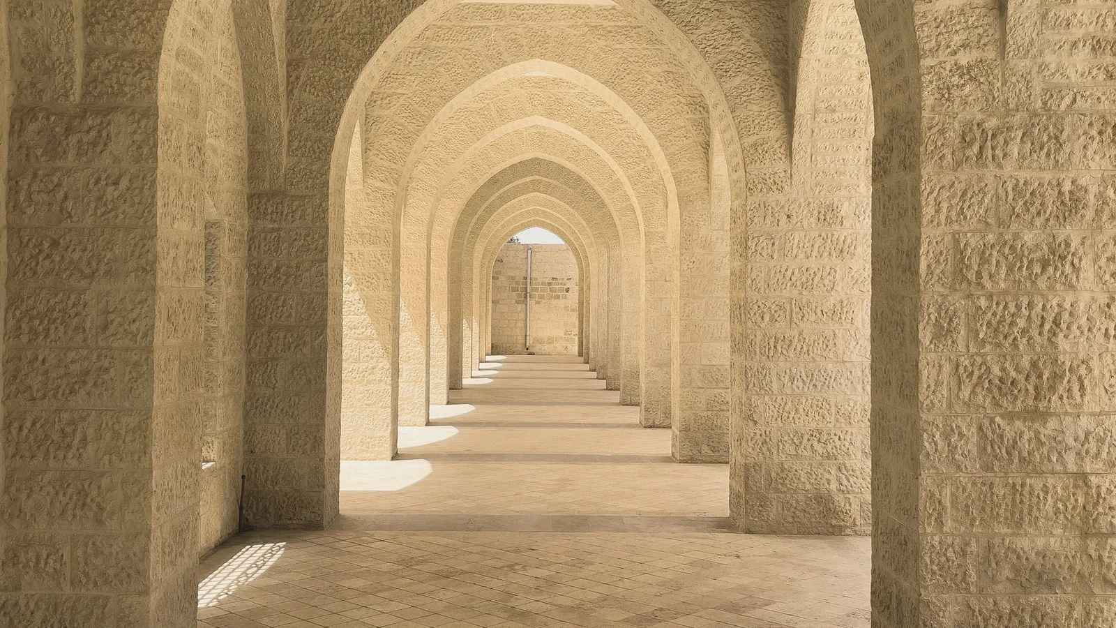 A long stone arcade, every arch open