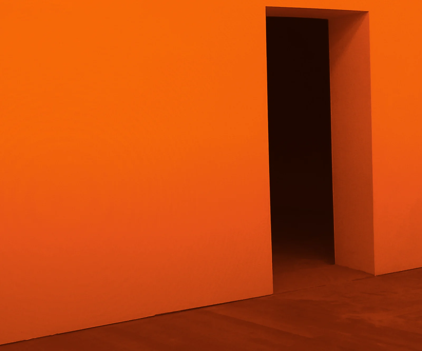 An open doorway in an orange wall